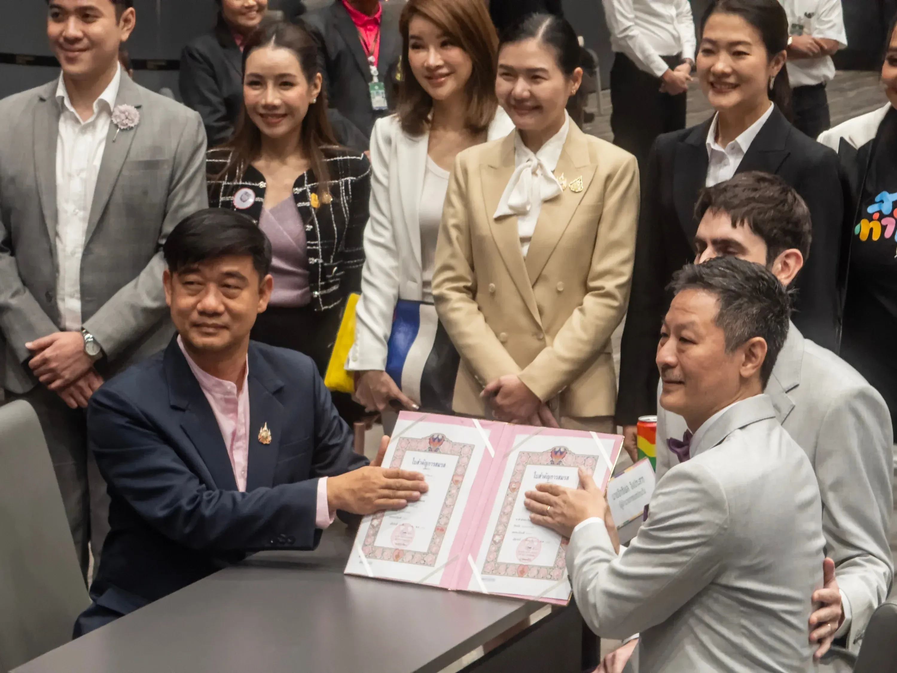 Official signing ceremony with a pride flag